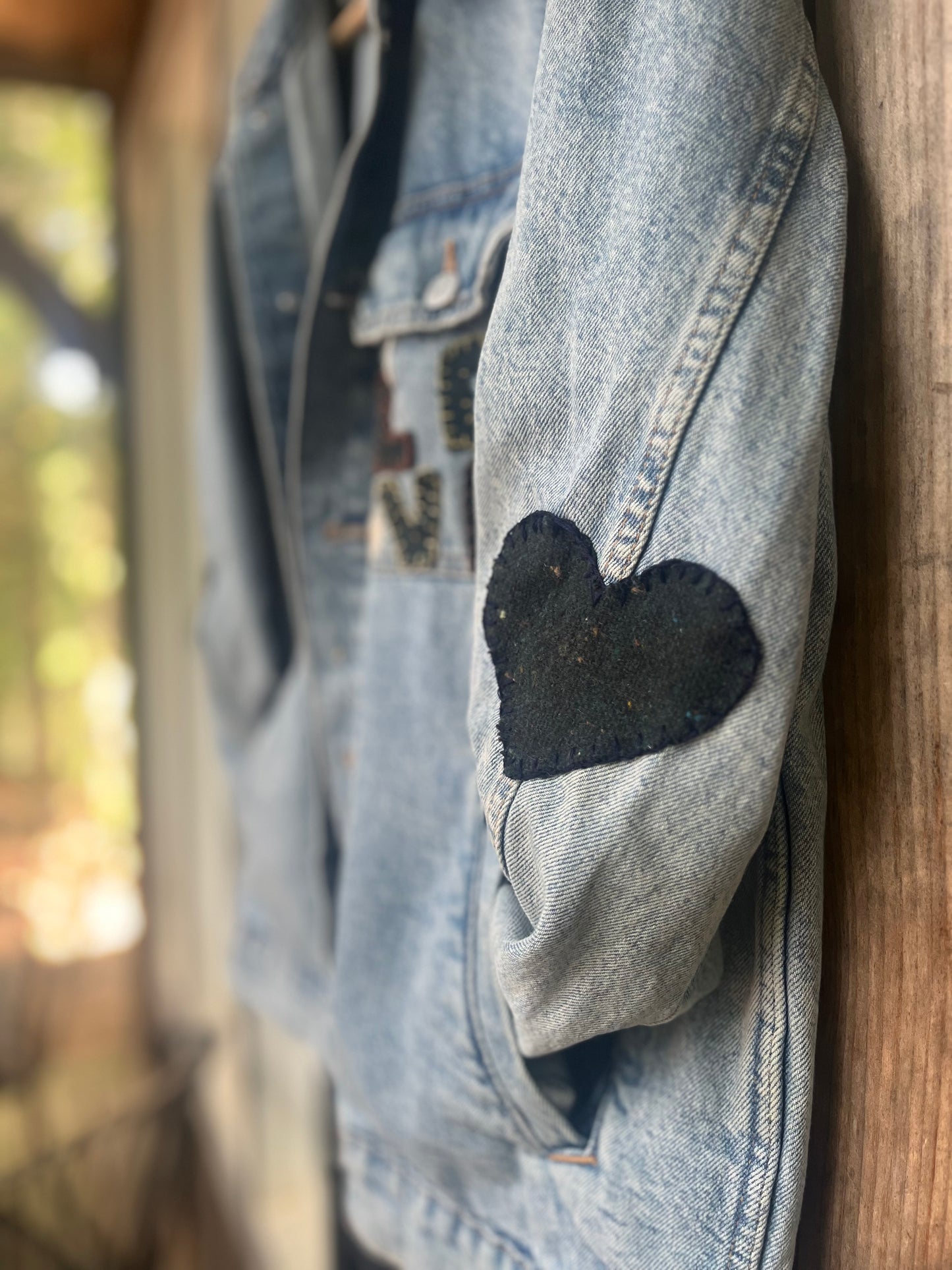 L O V E denim jacket with wool heart sleeves SIZE small (assuming men’s small)